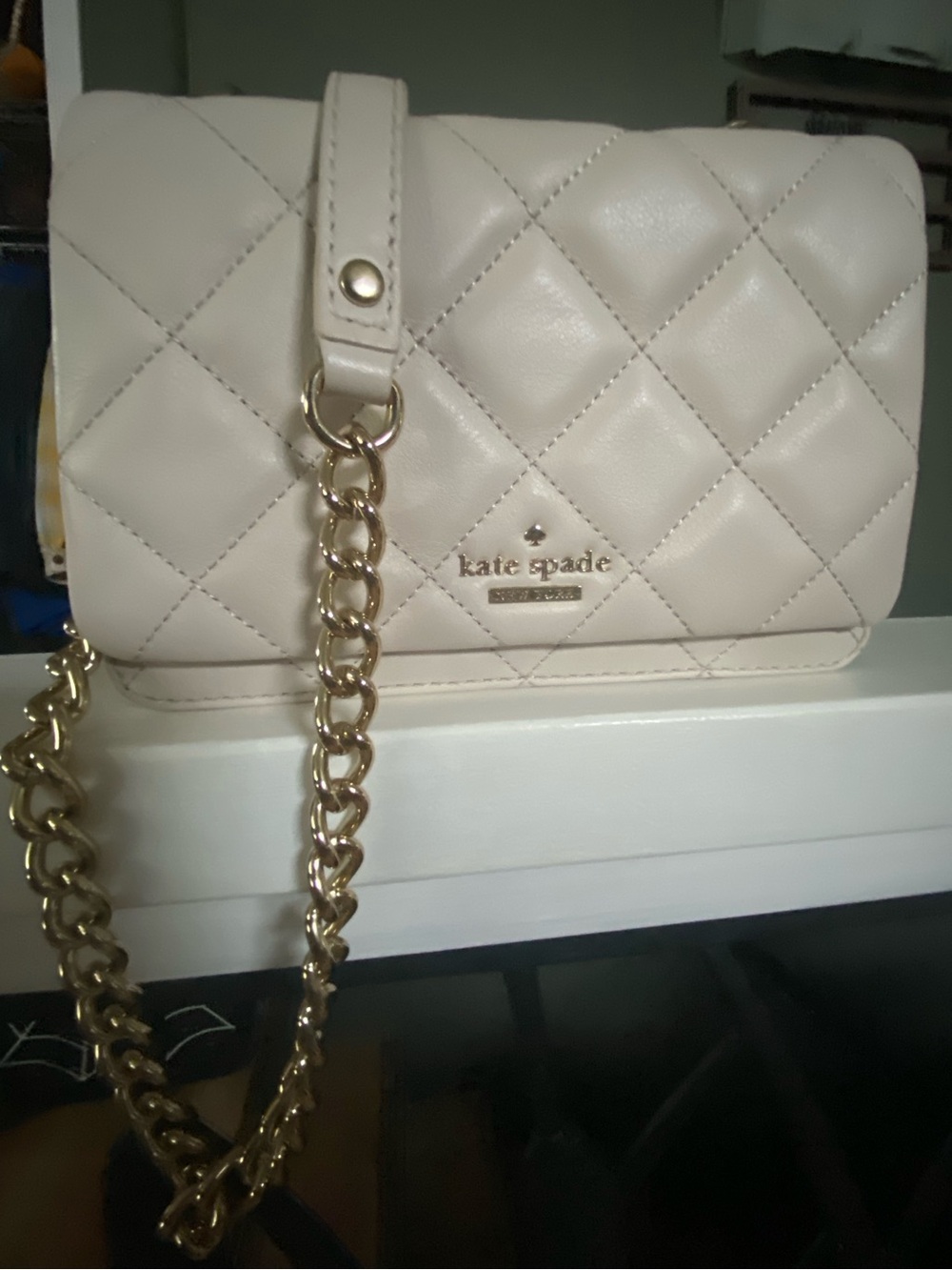 Mini Kate Spade quilted cream crossbody with adjustable strap